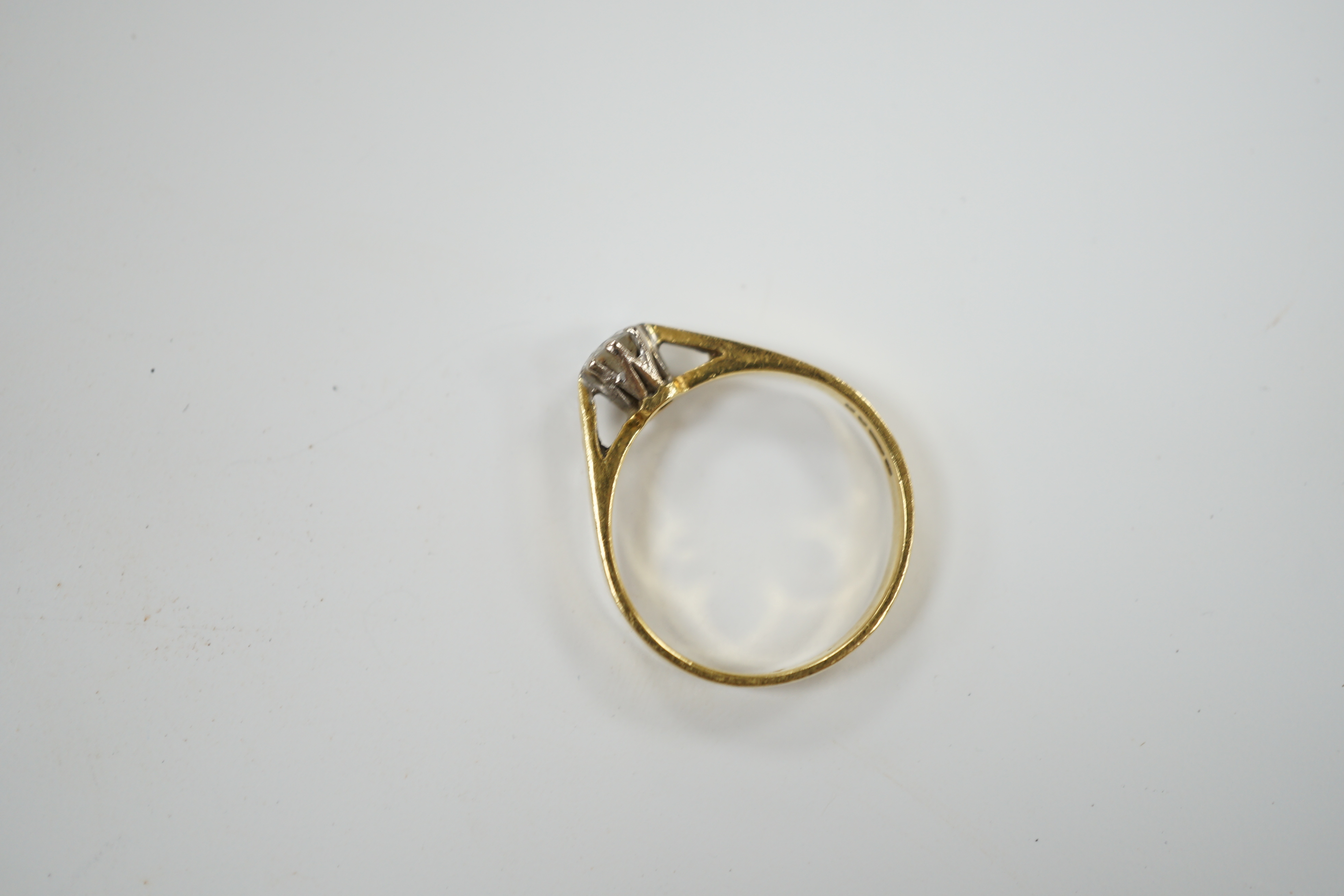 A modern 18ct gold and solitaire diamond set ring, size L/M, gross weight 2.4 grams.
